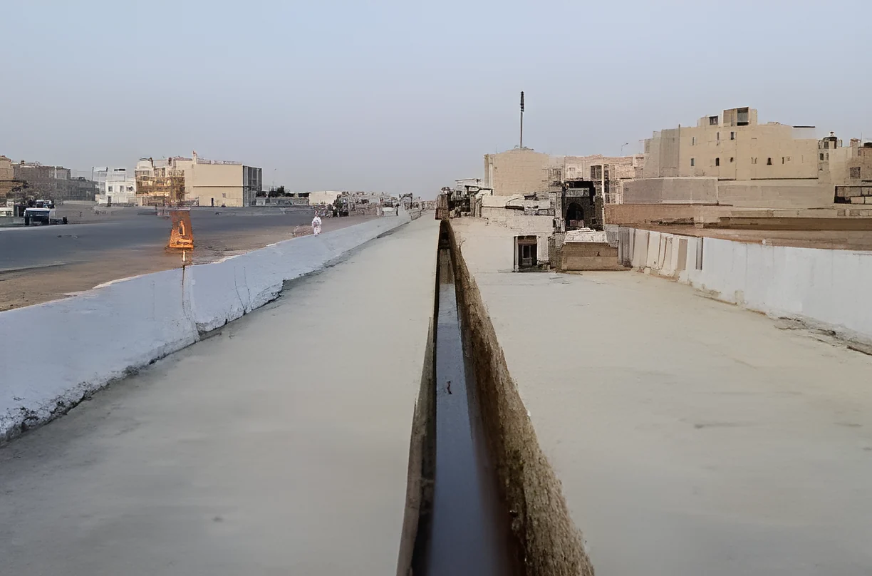 A long lined trench running beside the road in Khobar